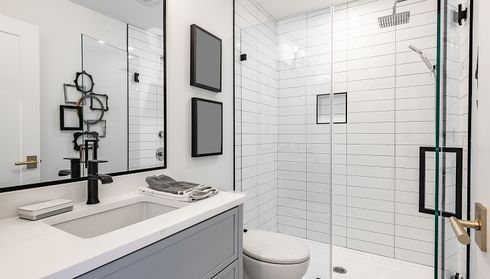 Modern walk-in shower with glass enclosure after bathtub removal