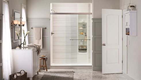 Walk-in shower conversion with built-in shelving and glass door