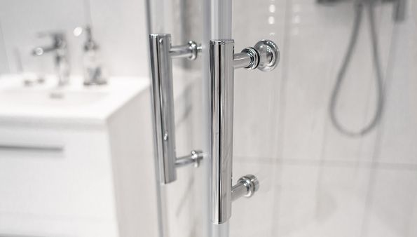 Close-up of glass walk-in shower door handle